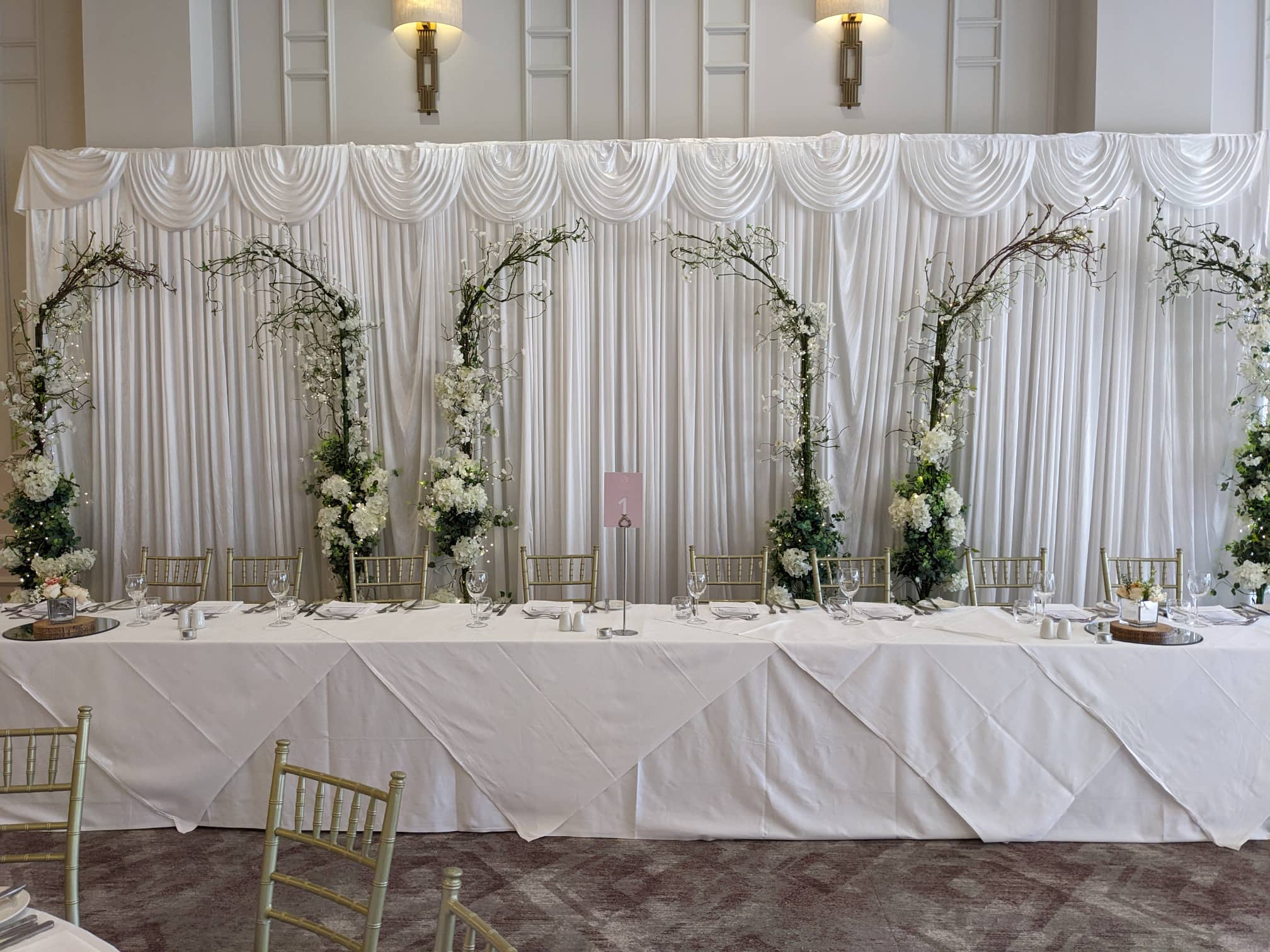 Silk backdrop with three sets of our enchanted arches in front of the backdrop